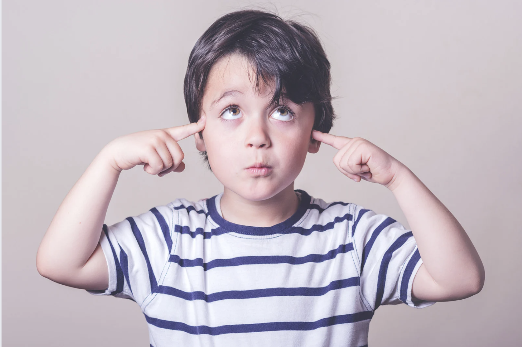 Young boy thoughtfully reflecting on a parenting question to manage urgent demands and prevent meltdowns.